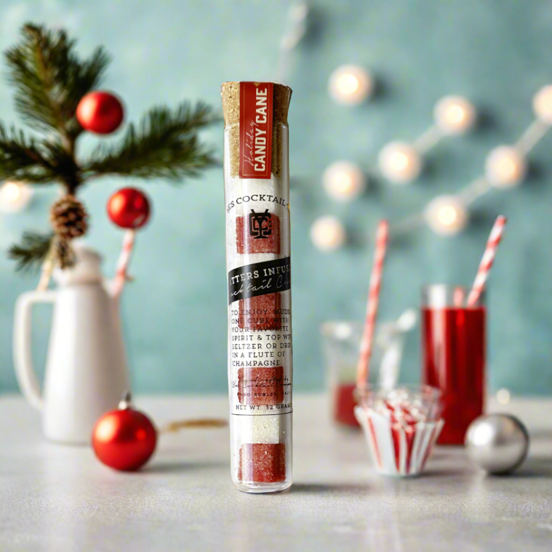 a tube of red and white drink mixer cubes on a holiday bar background