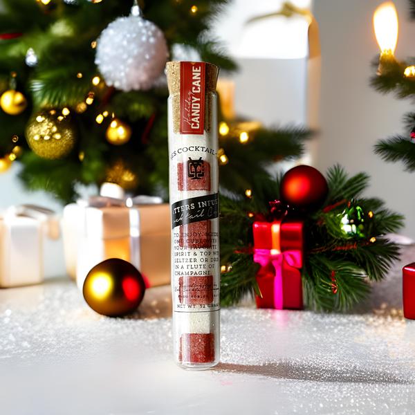 a test tube of red and white drink mixing cubes on a holiday background